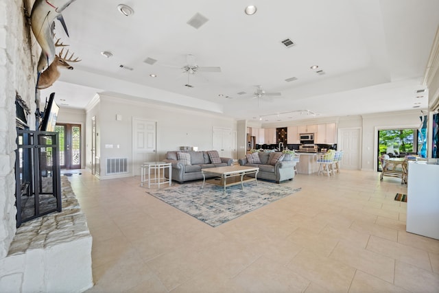 180 Hummel Ln, Coldspring, TX 77331 - living area with a tray ceiling, ornamental molding, plenty of natural light, recessed lighting, and a ceiling fan