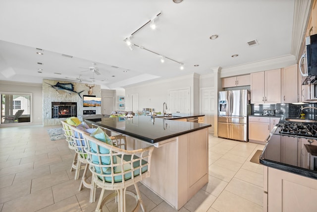 180 Hummel Ln, Coldspring, TX 77331 - kitchen with appliances with stainless steel finishes, dark countertops, ceiling fan, light tile patterned floors, and crown molding