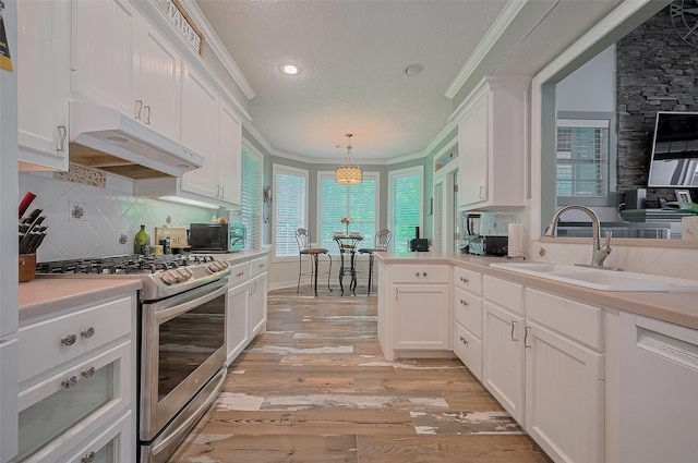 8946 Catamaran Way, Montgomery, TX 77316 - kitchen featuring stainless steel range with gas stovetop, white dishwasher, under cabinet range hood, a sink, and ornamental molding