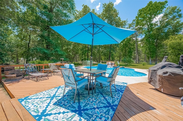 8946 Catamaran Way, Montgomery, TX 77316 - deck featuring an outdoor pool, outdoor dining area, and view of wooded area