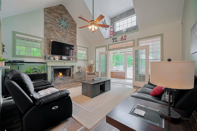 8946 Catamaran Way, Montgomery, TX 77316 - living area featuring ceiling fan, high vaulted ceiling, wood finished floors, and a stone fireplace