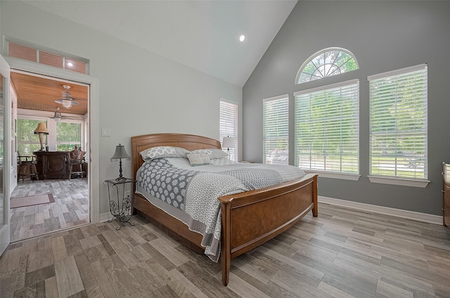 8946 Catamaran Way, Montgomery, TX 77316 - bedroom with high vaulted ceiling, multiple windows, wood finished floors, baseboards, and recessed lighting