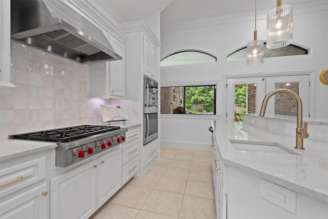 3706 Skyoak Ct, Spring, TX 77386 - kitchen with a sink, wall chimney exhaust hood, stainless steel appliances, decorative backsplash, and white cabinetry