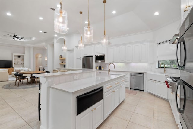 3706 Skyoak Ct, Spring, TX 77386 - kitchen featuring stainless steel appliances, a sink, a warming drawer, light tile patterned flooring, and ornamental molding