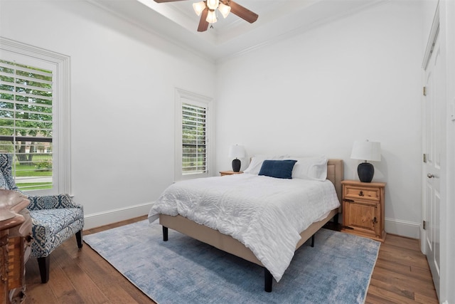 3706 Skyoak Ct, Spring, TX 77386 - bedroom with hardwood / wood-style floors, multiple windows, baseboards, a tray ceiling, and crown molding