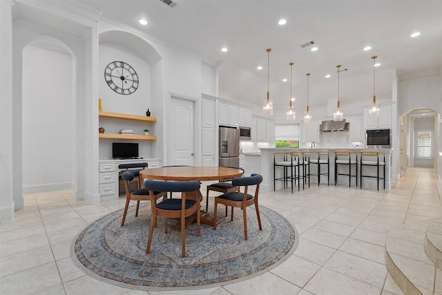 3706 Skyoak Ct, Spring, TX 77386 - dining space featuring arched walkways, light tile patterned flooring, recessed lighting, baseboards, and crown molding