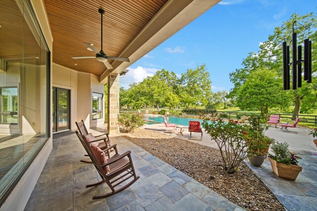 7527 Foster Island Dr, Richmond, TX 77406 - view of patio / terrace with ceiling fan and an outdoor pool