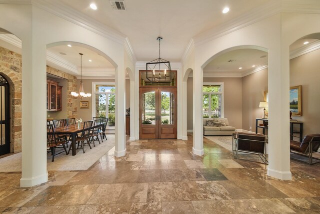 7527 Foster Island Dr, Richmond, TX 77406 - entrance foyer featuring plenty of natural light, stone tile floors, baseboards, a chandelier, and ornamental molding