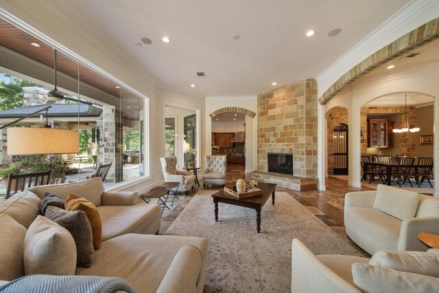 7527 Foster Island Dr, Richmond, TX 77406 - living area featuring arched walkways, ornamental molding, recessed lighting, healthy amount of natural light, and a chandelier
