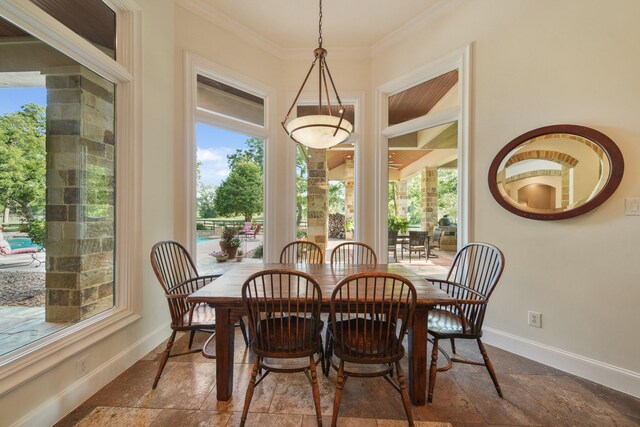 7527 Foster Island Dr, Richmond, TX 77406 - dining space with plenty of natural light, stone tile floors, baseboards, and crown molding