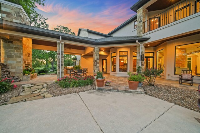 7527 Foster Island Dr, Richmond, TX 77406 - patio terrace at dusk with a patio area, outdoor dining space, and a balcony