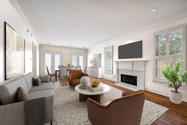 living area with plenty of natural light, crown molding, wood finished floors, a fireplace, and baseboards