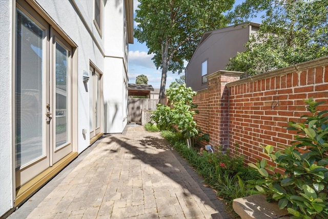 view of side of home featuring fence and a patio area