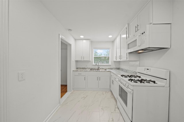 5023 Hull St, Houston, TX 77021 - kitchen with white appliances, a sink, light marble finish floors, white cabinetry, and light stone counters