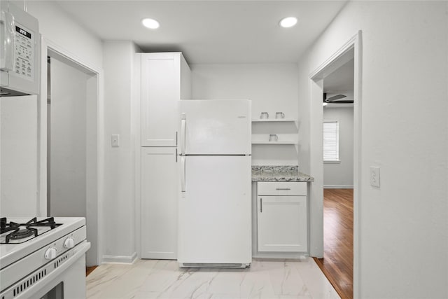 5023 Hull St, Houston, TX 77021 - kitchen featuring white appliances, recessed lighting, light stone countertops, white cabinets, and light marble finish floors