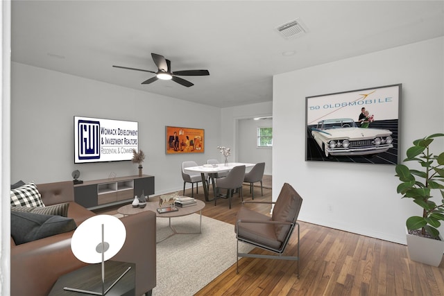 5023 Hull St, Houston, TX 77021 - living area with wood finished floors, baseboards, and a ceiling fan