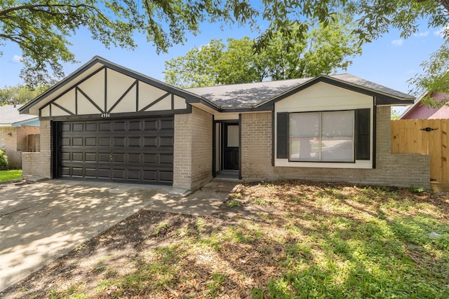 4904 Deerwood Cir, Baytown, TX 77521 - view of front of property featuring brick siding, driveway, an attached garage, fence, and roof with shingles