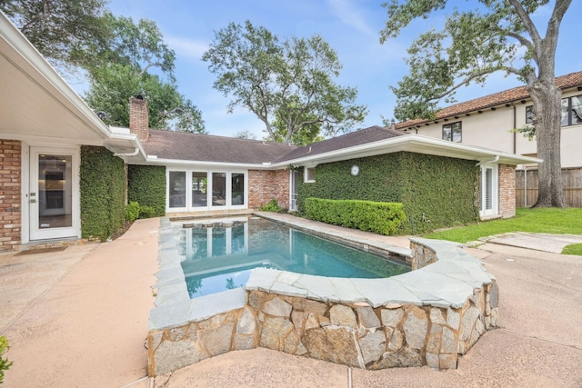 swimming pool with a patio and fence