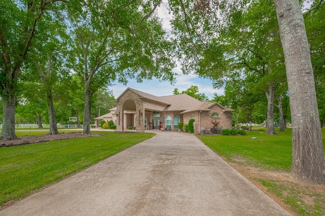 18518 W Paloma Lago Cir, Cypress, TX 77433 - view of front of house featuring brick siding, a front yard, driveway, and a shingled roof