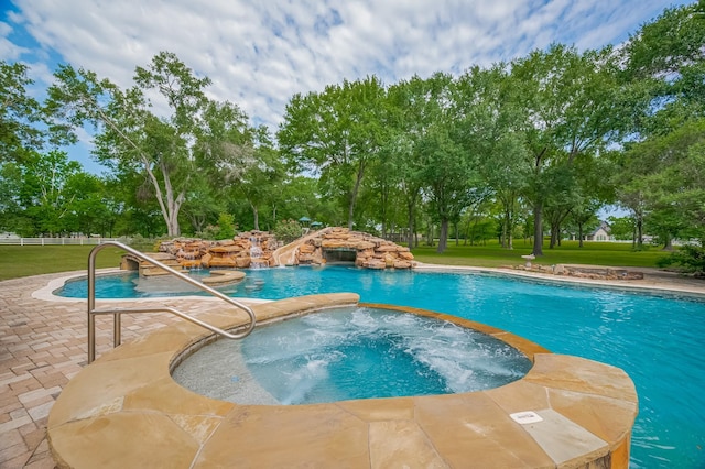 18518 W Paloma Lago Cir, Cypress, TX 77433 - view of pool featuring a pool with connected hot tub, a yard, a patio area, and view of wooded area