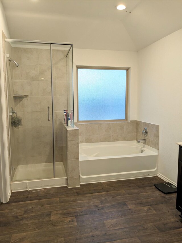 18475 Tenaha Mill Dr, New Caney, TX 77357 - bathroom featuring a garden tub, a stall shower, lofted ceiling, wood finished floors, and vanity