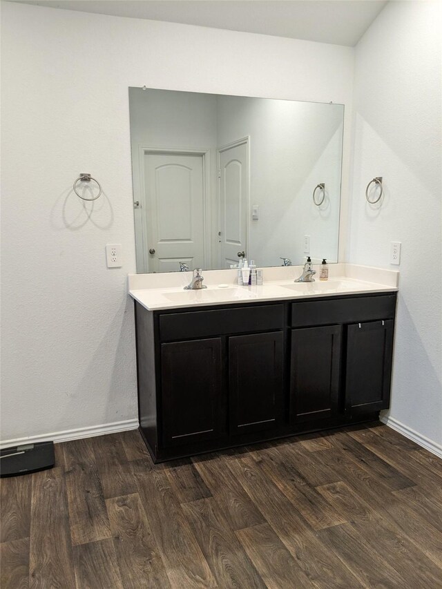 18475 Tenaha Mill Dr, New Caney, TX 77357 - bathroom featuring wood finished floors, baseboards, and double vanity