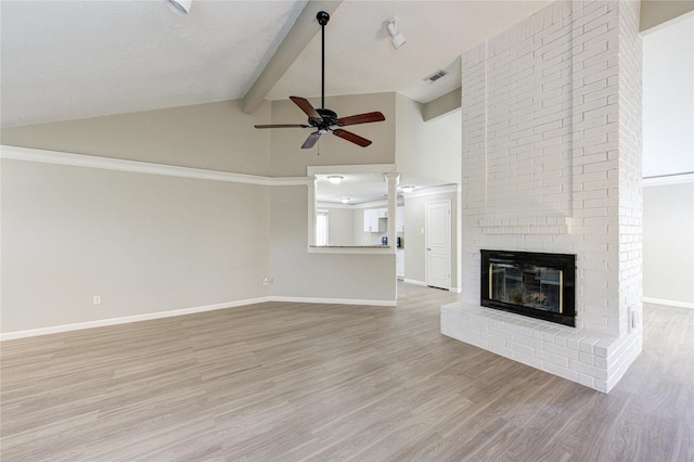 2036 Woodland Hills Dr, Missouri City, TX 77489 - unfurnished living room featuring a ceiling fan, baseboards, light wood-style floors, beamed ceiling, and a fireplace