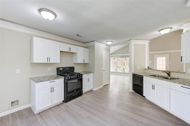 2036 Woodland Hills Dr, Missouri City, TX 77489 - kitchen with black appliances, a sink, a textured ceiling, light wood-style floors, and baseboards