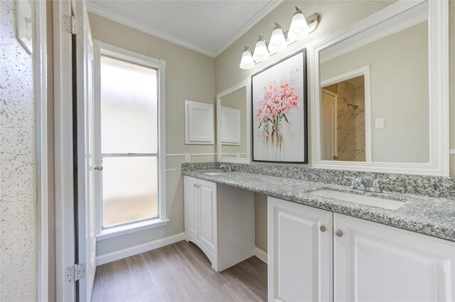 2036 Woodland Hills Dr, Missouri City, TX 77489 - bathroom with double vanity, crown molding, wood finished floors, and a tile shower