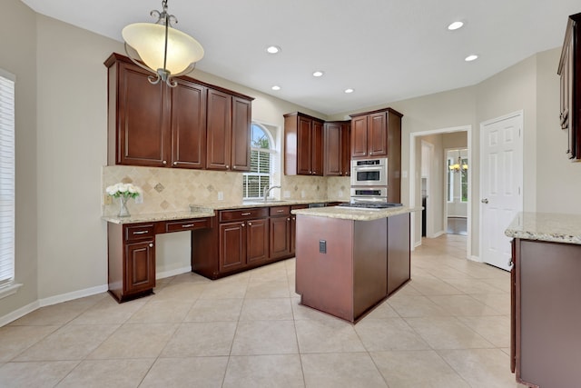 kitchen with tasteful backsplash, light tile patterned flooring, light stone countertops, recessed lighting, and pendant lighting