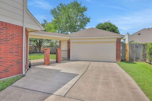 view of front facade with brick siding, a garage, concrete driveway, a shingled roof, and a gate
