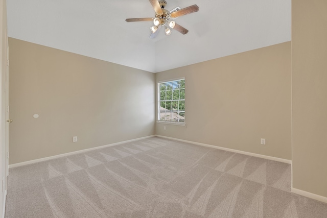 empty room with light carpet, a ceiling fan, baseboards, and lofted ceiling