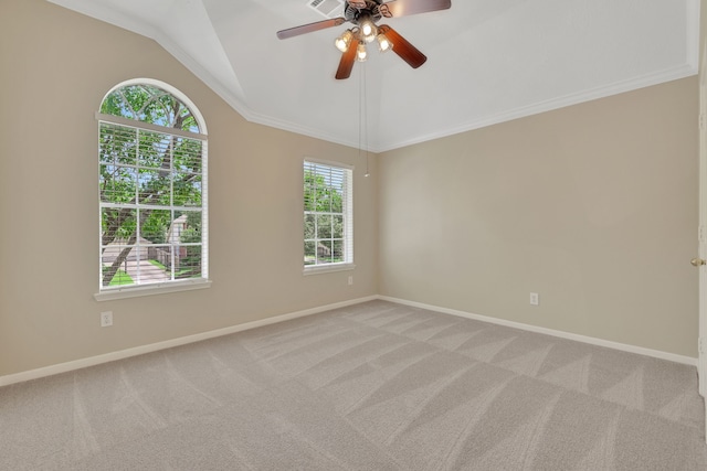 empty room featuring ceiling fan, lofted ceiling, baseboards, and light carpet