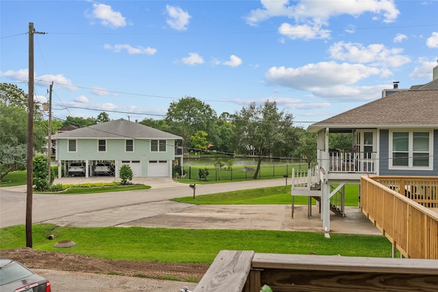 268 Seminole Dr, League City, TX 77565 - view of yard with concrete driveway, stairway, an attached garage, and covered porch