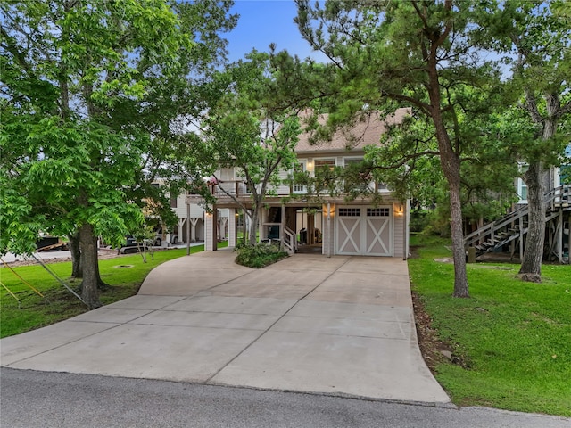 268 Seminole Dr, League City, TX 77565 - view of front of house featuring stairs, concrete driveway, an attached garage, and a front lawn