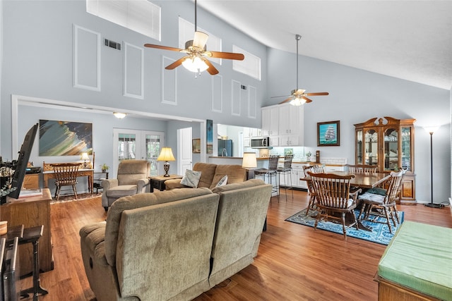 268 Seminole Dr, League City, TX 77565 - living room featuring a ceiling fan, high vaulted ceiling, and wood finished floors