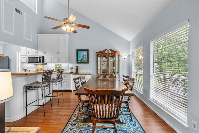268 Seminole Dr, League City, TX 77565 - dining room with high vaulted ceiling, a ceiling fan, and wood finished floors