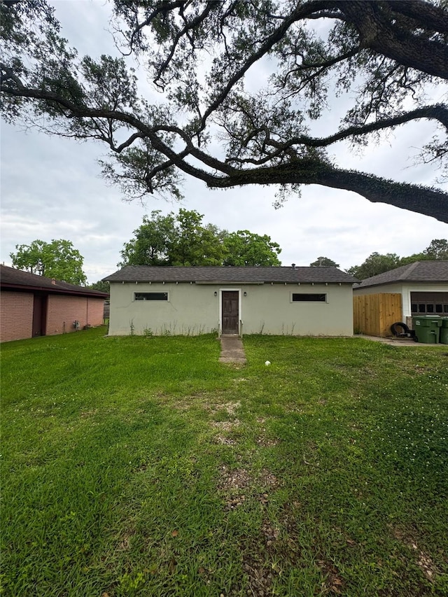 101 W St, Liberty, TX 77575 - back of house featuring stucco siding