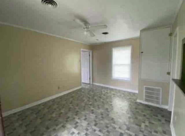 101 W St, Liberty, TX 77575 - unfurnished living room with ceiling fan and baseboards