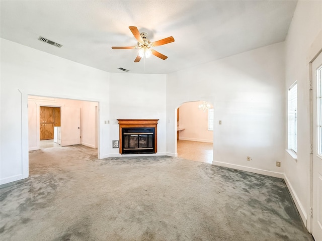 102 Besch Wilburn Ln, Glidden, TX 78943 - unfurnished living room with ceiling fan, arched walkways, carpet flooring, and baseboards