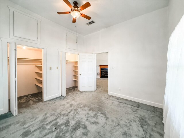 102 Besch Wilburn Ln, Glidden, TX 78943 - unfurnished bedroom featuring carpet flooring, a spacious closet, baseboards, and a towering ceiling