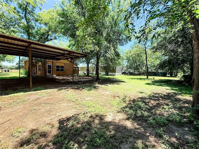 102 Besch Wilburn Ln, Glidden, TX 78943 - view of green lawn featuring a carport