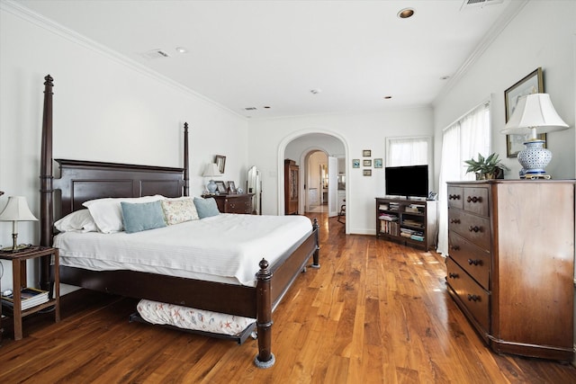 1755 Kipling St, Houston, TX 77098 - bedroom featuring arched walkways, ornamental molding, hardwood / wood-style floors, and recessed lighting