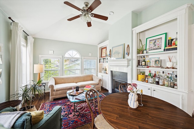 1755 Kipling St, Houston, TX 77098 - living area featuring dark wood-style flooring, lofted ceiling, ceiling fan, and a tiled fireplace