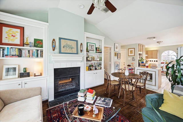 1755 Kipling St, Houston, TX 77098 - living area featuring vaulted ceiling, a ceiling fan, a fireplace, and built in features