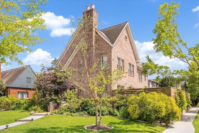 1755 Kipling St, Houston, TX 77098 - view of home's exterior with brick siding, a yard, and a chimney