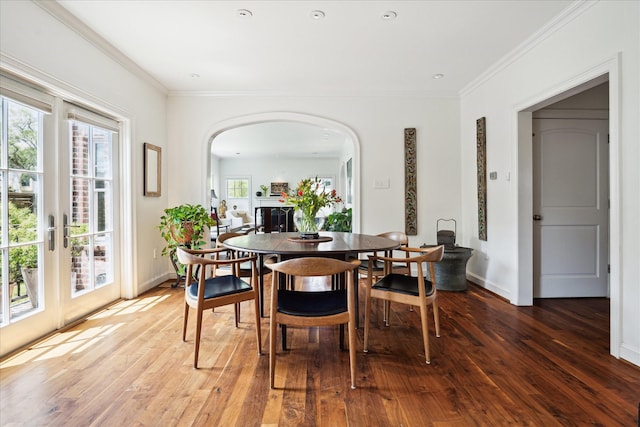 1755 Kipling St, Houston, TX 77098 - dining space with arched walkways, hardwood / wood-style floors, ornamental molding, and baseboards