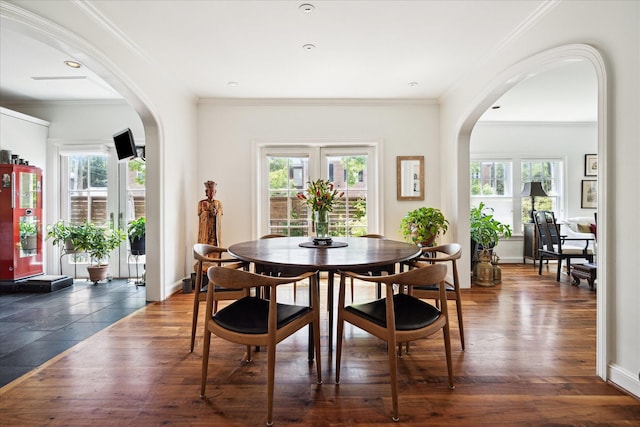 1755 Kipling St, Houston, TX 77098 - dining space featuring arched walkways, ornamental molding, wood finished floors, and baseboards