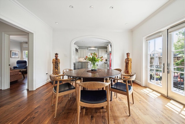 1755 Kipling St, Houston, TX 77098 - dining area featuring arched walkways, wood finished floors, crown molding, and baseboards