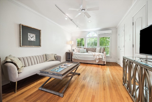 1755 Kipling St, Houston, TX 77098 - living area featuring ornamental molding, a wall mounted AC, track lighting, light wood finished floors, and baseboards